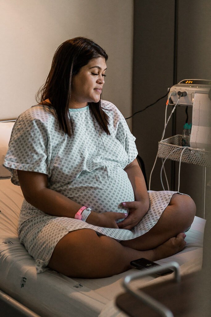Woman sitting on a hospital bed in early labor